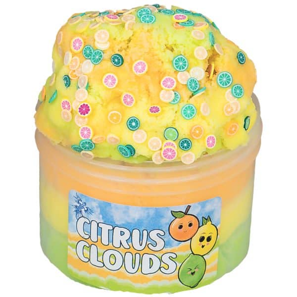 A translucent jar is filled with layers of green, yellow, and orange cloud slime, which are also swirled together in a fluffy pile on top. The pile is covered in colorful citrus slice sprinkles and the label on the jar says citrus clouds slime.