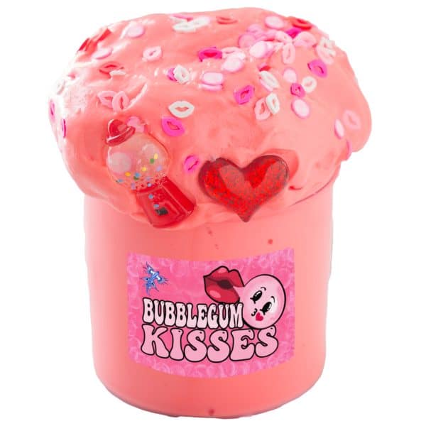 A clear jar is packed with pink slime, piled high above the rim. The mound of slime is topped with lips sprinkles, pink bubble sprinkles, a red heart charm, and a gumball machine charm. A label on the jar reads Bubblegum Kisses Slime.