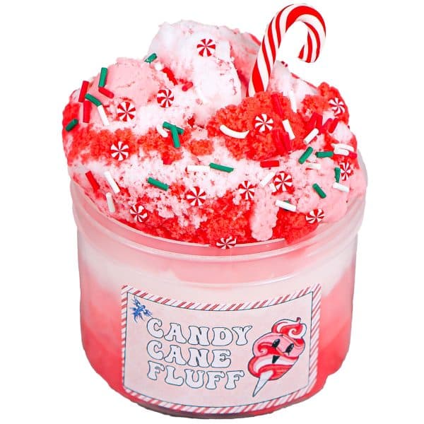 A clear jar is layered with red, pink, and white cloud slime. The slimes are swirled together in a fluffy pile high above the top of the jar, and covered in fake christmas sprinkles. A realistic looking polymer mini candy cane is poked into the mountain of fluff and a label on the jar reads Candy Cane Slime Fluff.